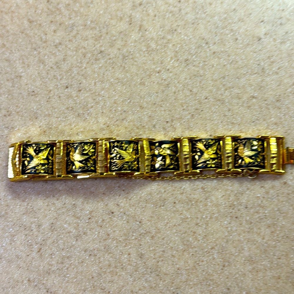 Bird bracelet. Gold tone with black and golden colored birds.